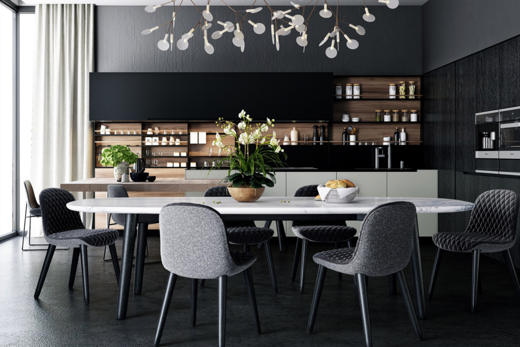 Essbereich mit Küche im Hintergrund. die farben sind dunkel gehalten, so dass ein sehr edler Look entsteht. auf dem Tisch steht eine pflanze und der Essbereich lädt zum platz nehmen ein